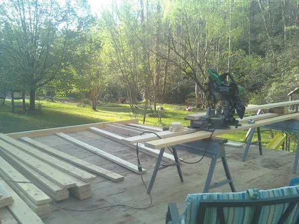 Miter saw and framing lumber on a deck under construction in Mukilteo