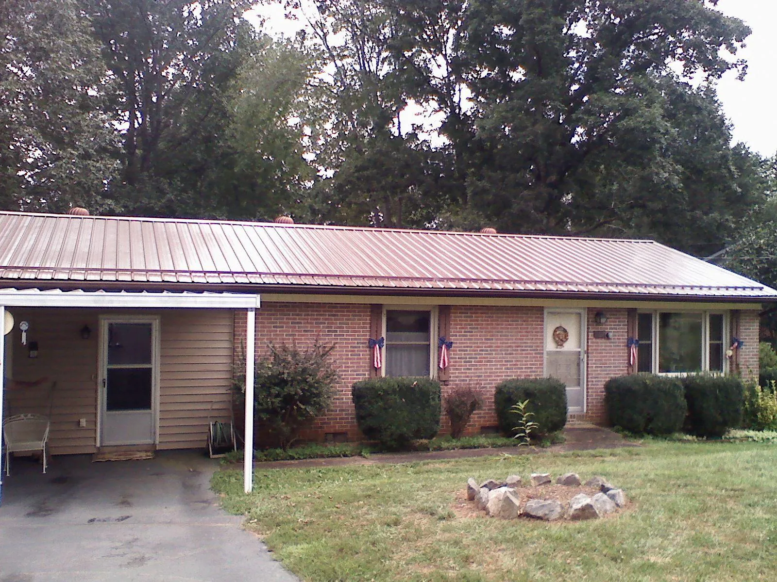 Bronze metal roof and carport on a brick ranch home — Roof Repair work by our crew in Mukilteo